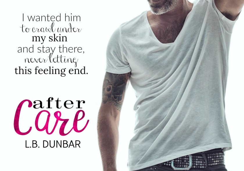 A mature bearded man with tattoos standing against a white background